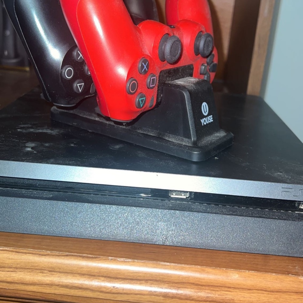 PlayStation 4 slim with two controllers and controller charger!